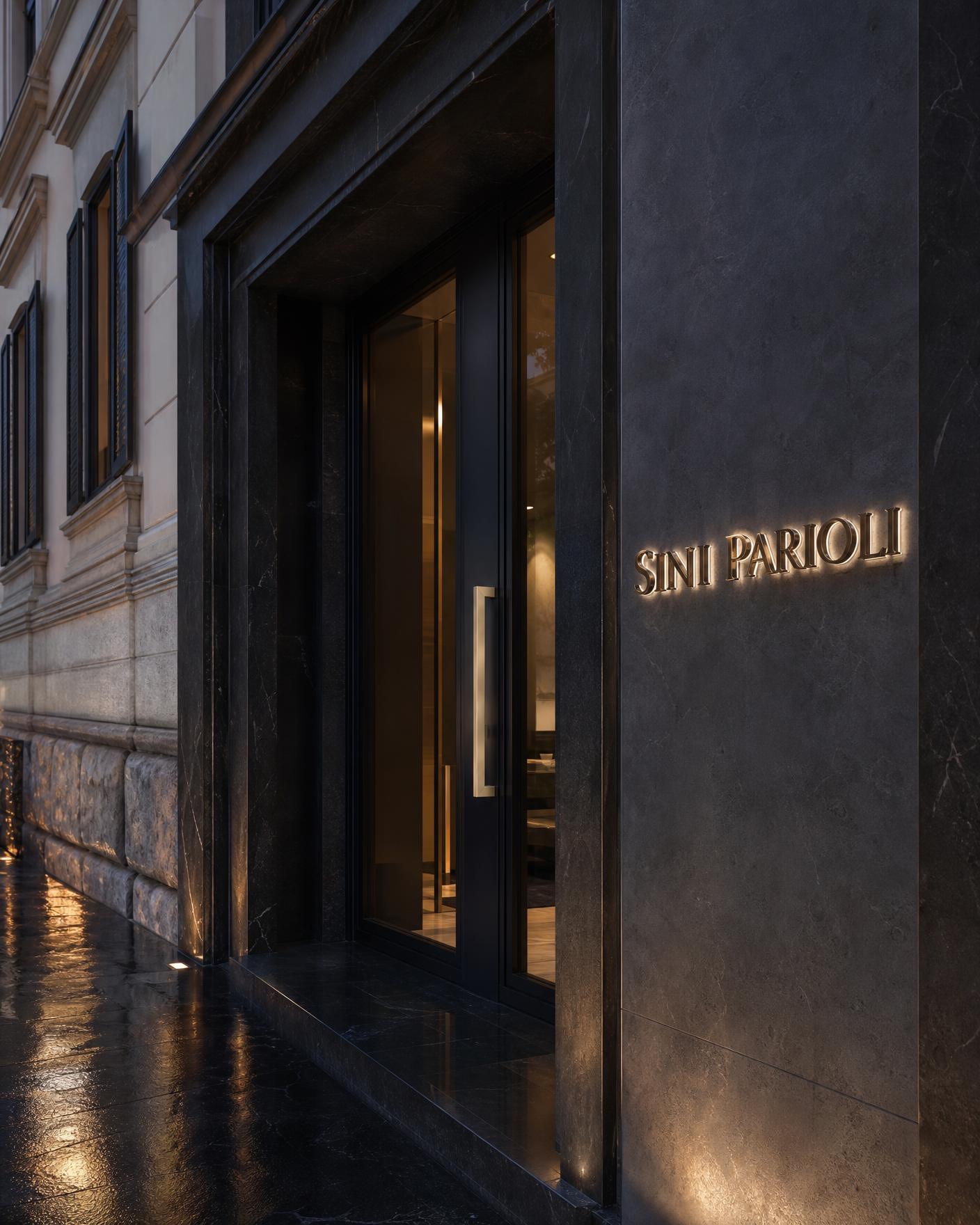 Ingresso dello studio Sini Parioli in un palazzo dei Parioli, insegna in metallo champagne sulla parete in pietra scura
